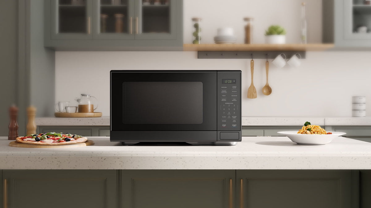 Mainstays Countertop Microwave Oven, Automatic Defrost, 1000W, 1.1 cu ft, Black — reference 4